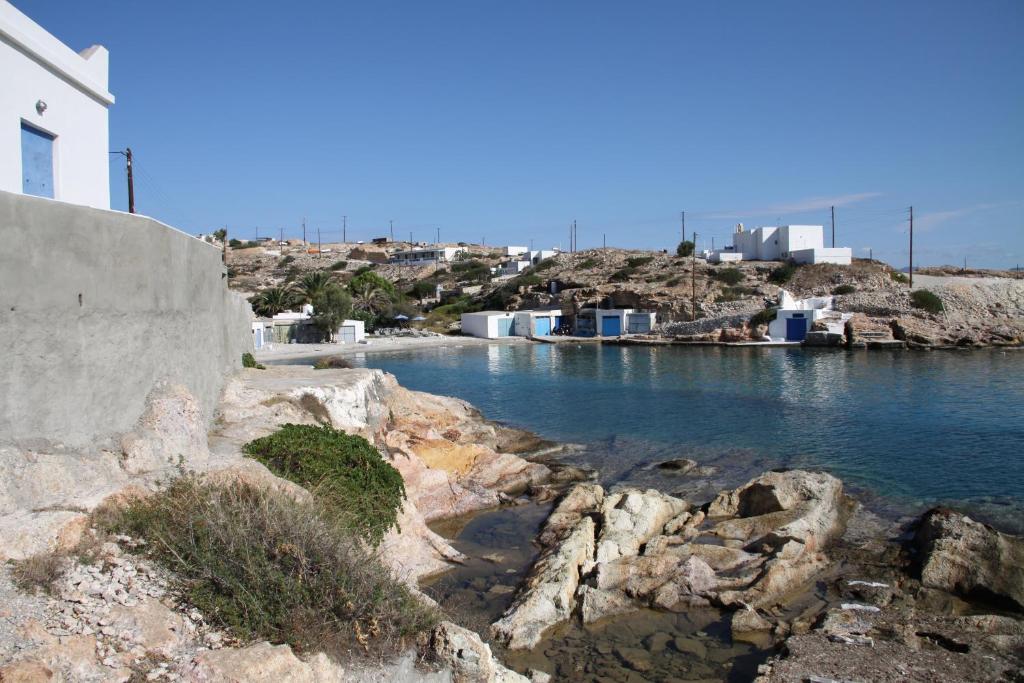 a body of water with buildings in the background at Cavo Paradise Kimolos in Kimolos