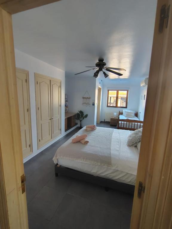 a bedroom with a bed and a ceiling fan at Natura Escapade Guesthouse in Torrox