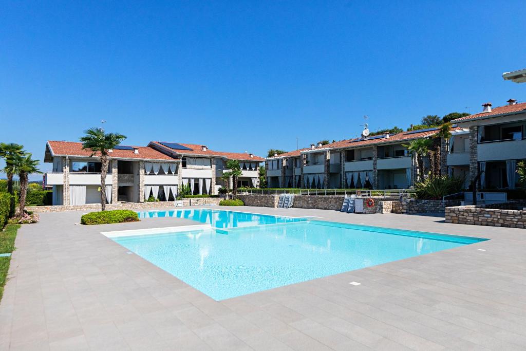 a swimming pool in front of some apartment buildings at Vivere il Parco in Lonato