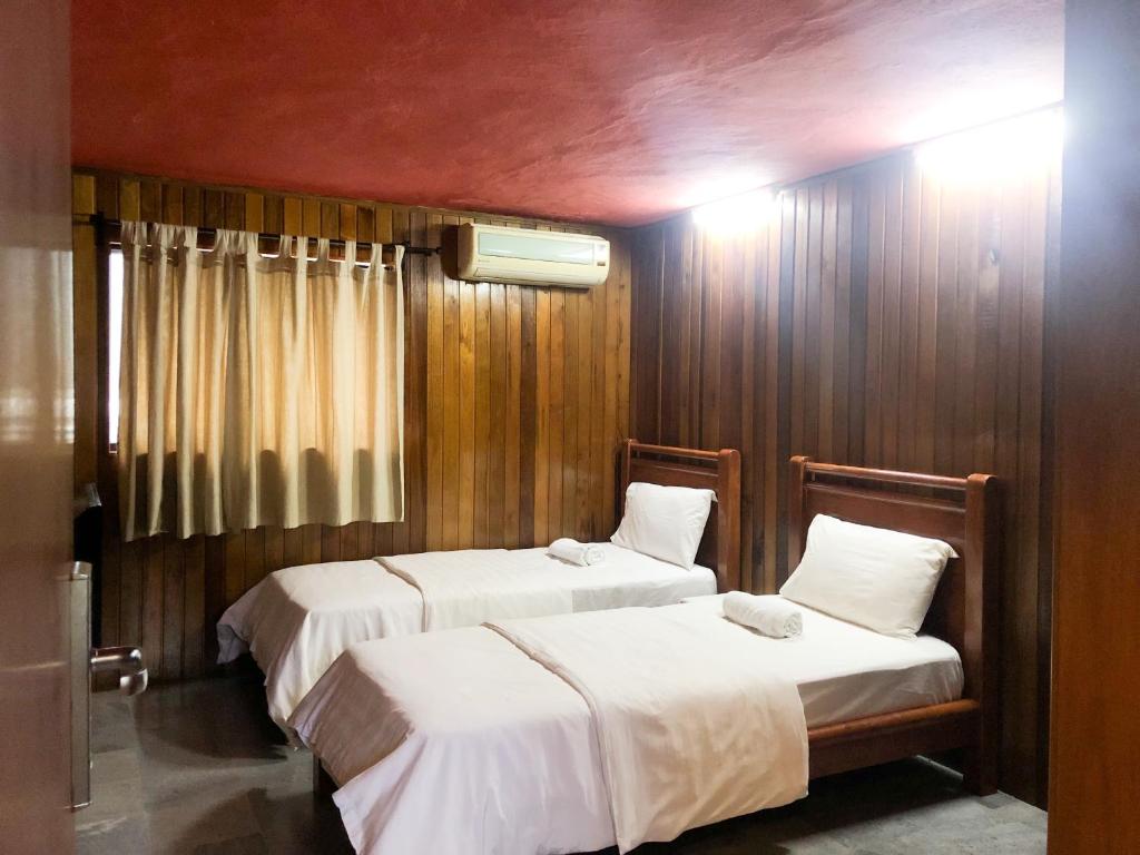 Ένα ή περισσότερα κρεβάτια σε δωμάτιο στο I vilainn Bukit Bintang