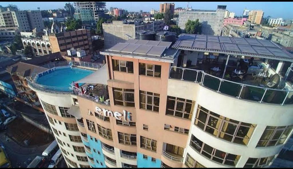 a building with a swimming pool on top of it at Emeli Hotel Luxury Suites in Nairobi