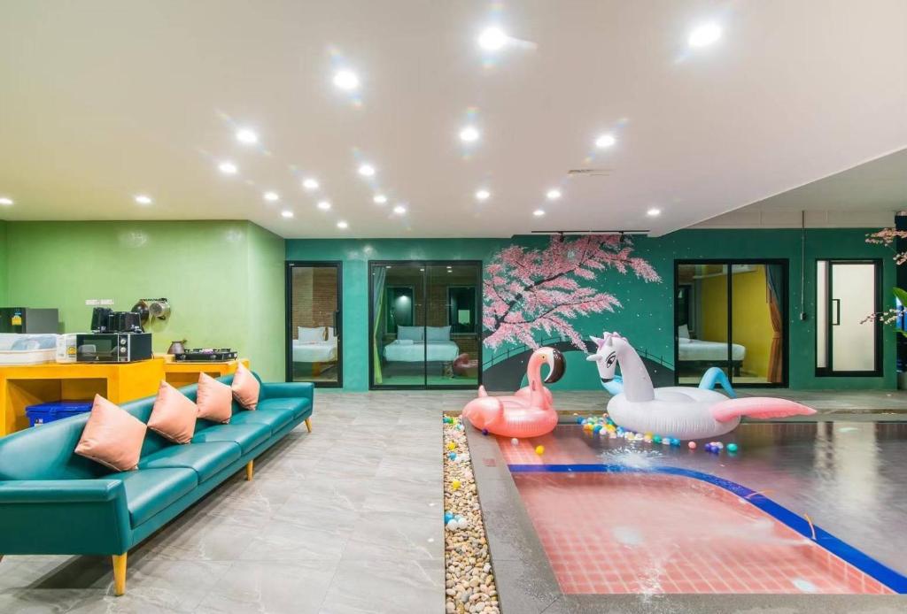 a living room with a couch and two pink flamingos at Le Villa Huahin in Ban Khao Rang