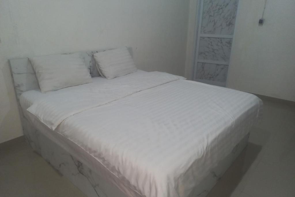 Voodi või voodid majutusasutuse Capital O 94901 Kostel Naga toas