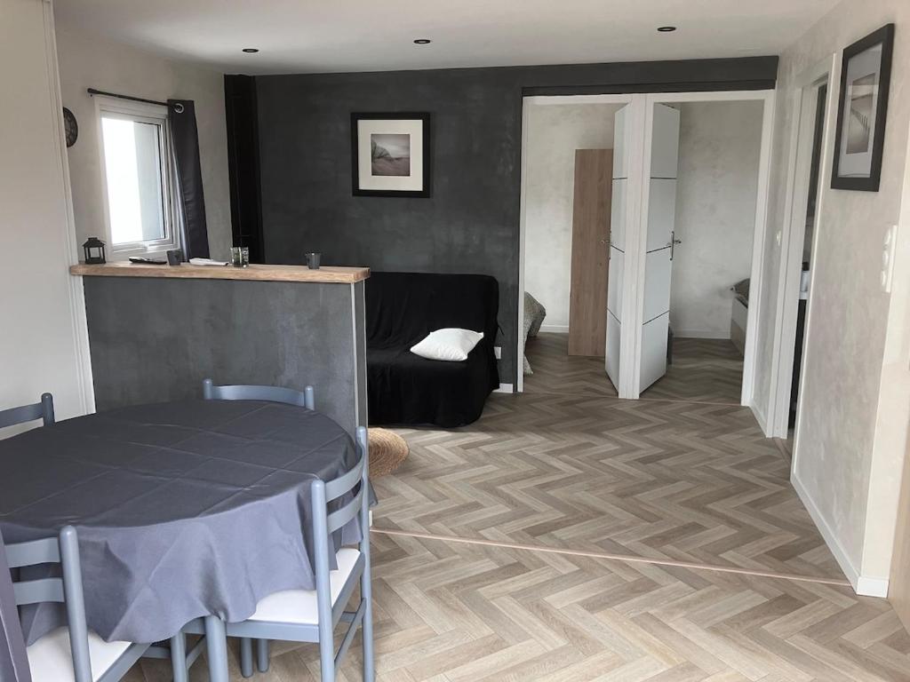 a living room with a table and a couch at Le refuge sablais in Les Sables-dʼOlonne