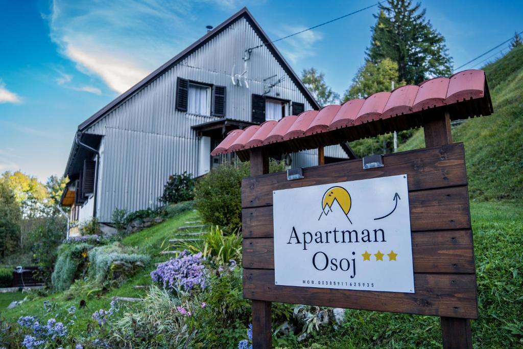 a sign in front of a house at Apartman Osoj Mrzla Vodica in Mrzla Vodica