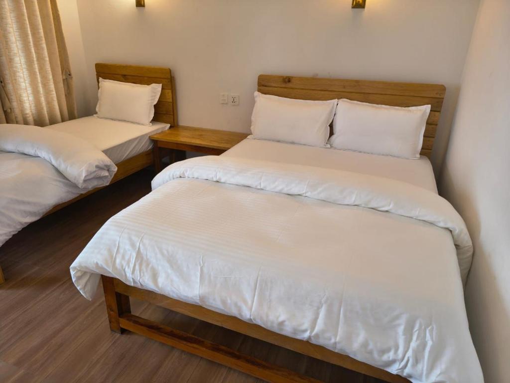 Una cama o camas en una habitación de RJ Boutique Hotel - Ghandruk
