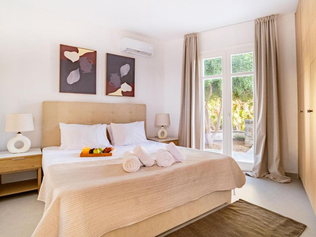a bedroom with a large bed with towels on it at Sanders Paros Gardens in Molos Parou