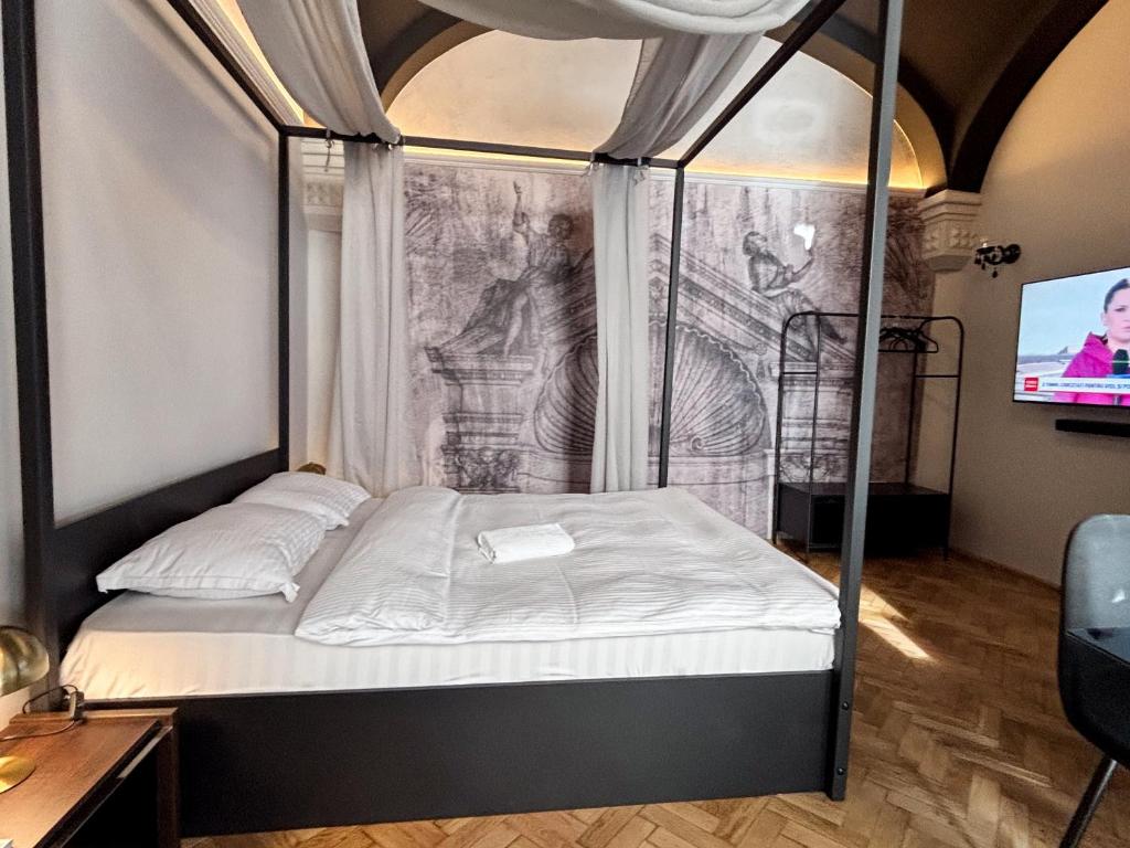 a bed in a room with a drawing on the wall at Moonlight City Center Studio Private Parking in Cluj-Napoca