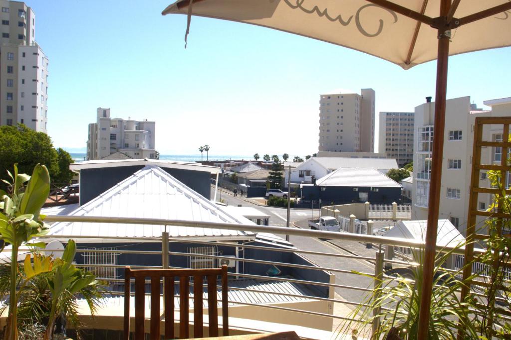 a balcony with a view of a boat in a city at Ocean Escape in Strand