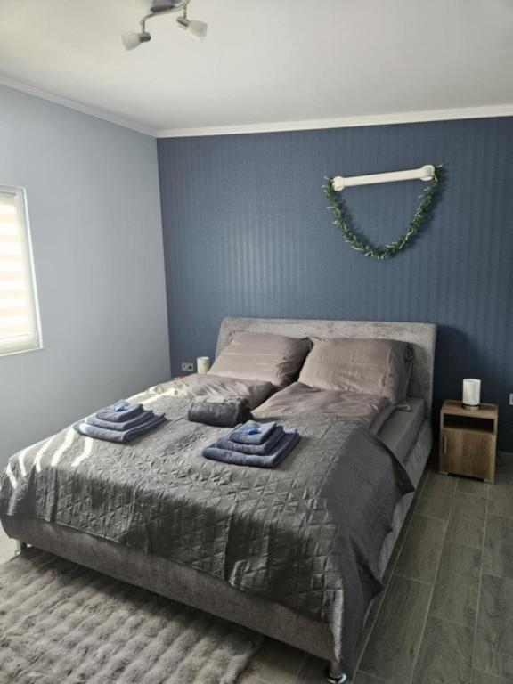 a bedroom with a bed with two towels on it at Áron Apartman in Tiszafüred