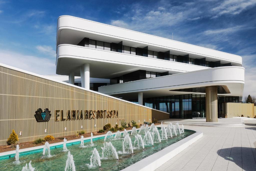 ein Gebäude mit einem Brunnen davor in der Unterkunft Elania Resort & Spa in Cluj-Napoca