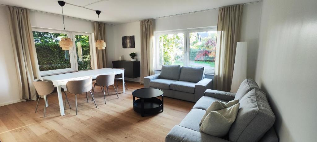 a living room with a couch and a table and chairs at Storch Appartements Limburg in Hundsangen