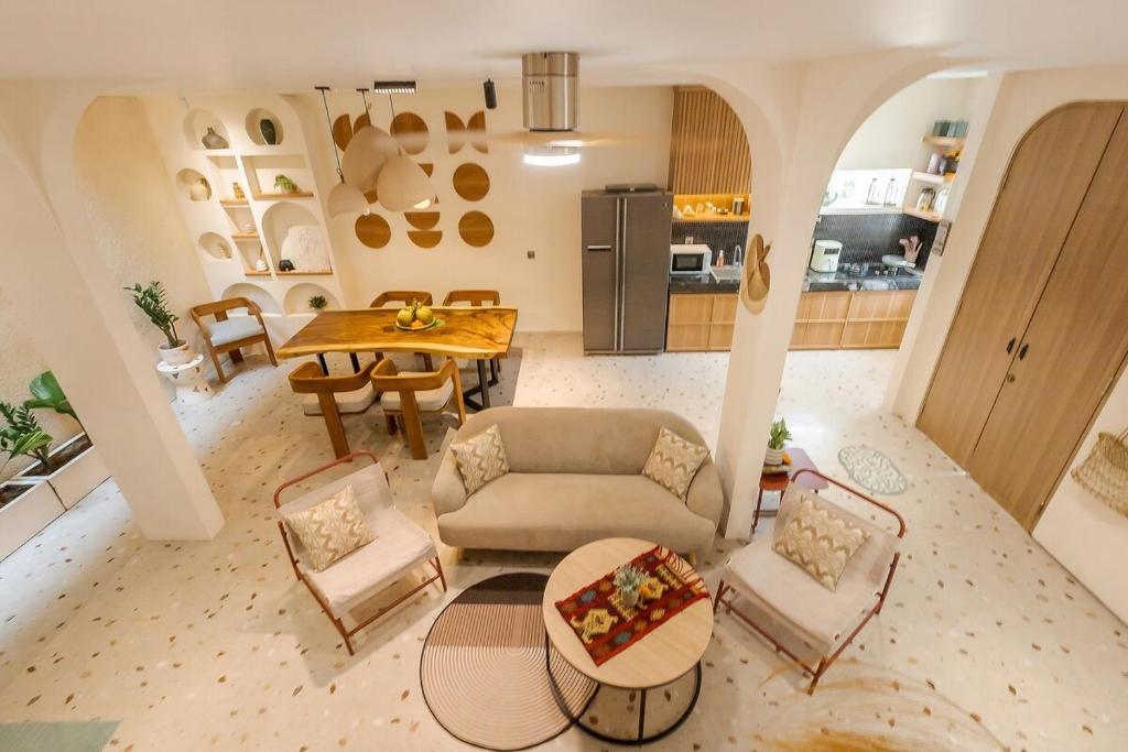 an aerial view of a living room with a table and chairs at The Shalak Villa Bali in Denpasar