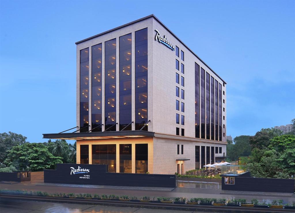 a building with a sign on the side of it at Radisson Mumbai Andheri MIDC in Mumbai