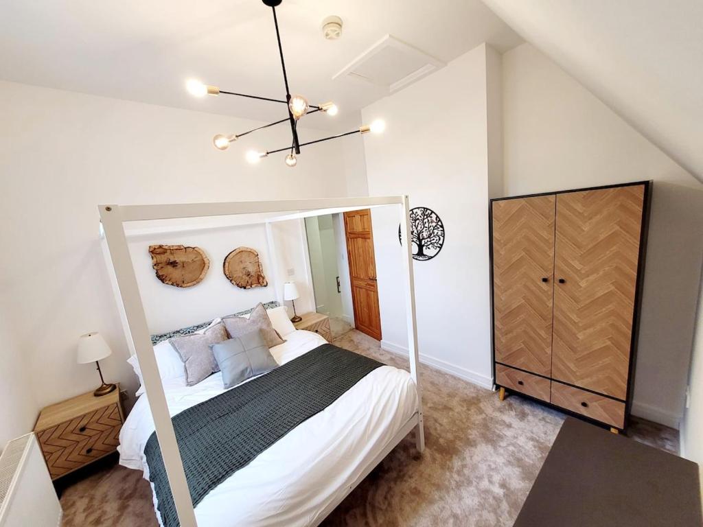 a bedroom with a large bed and a mirror at Perfect Base for Work or Leisure Unique Two-Bed in Irlam
