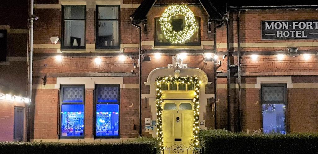 a building with a yellow door and a christmas wreath at The Mon Fort in Bridlington