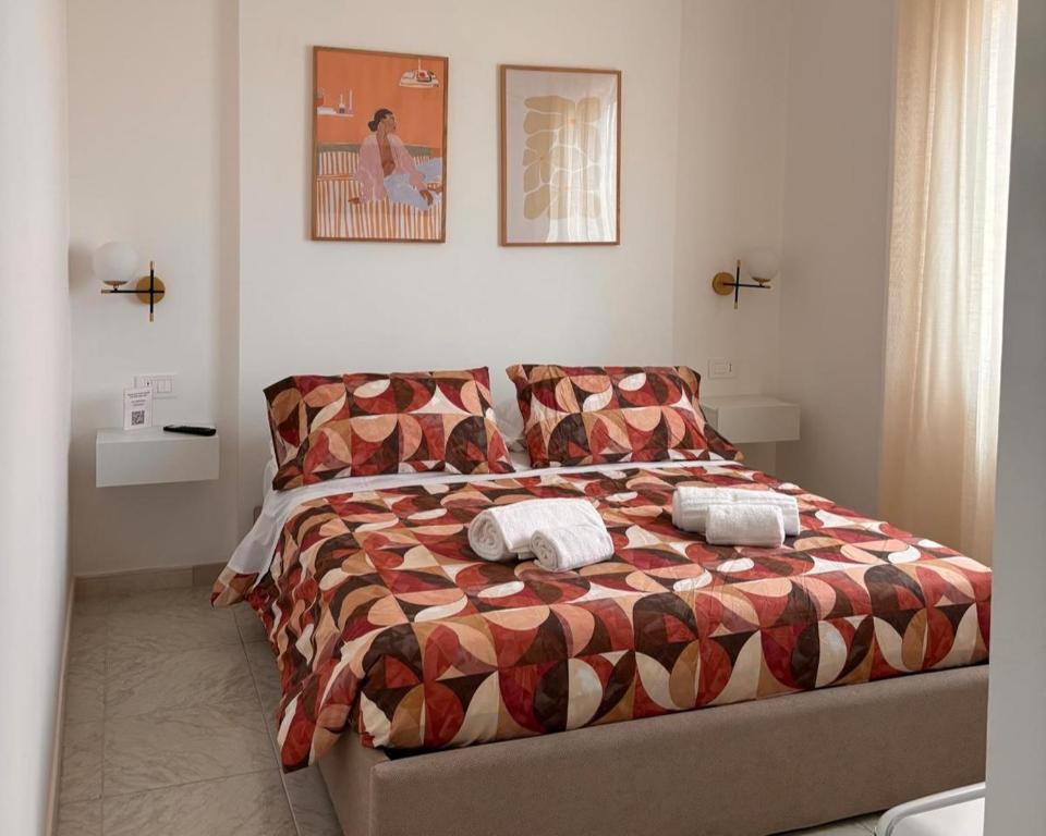 a bedroom with a bed with two pillows on it at Be Your Home - Cruise Stop Guest House in Civitavecchia