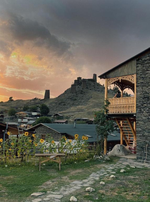 a building with a view of a castle on a hill at A North Homestay in Omalo