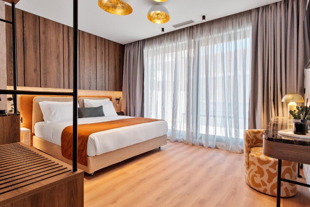 Ένα ή περισσότερα κρεβάτια σε δωμάτιο στο Acropolis Grid Athens