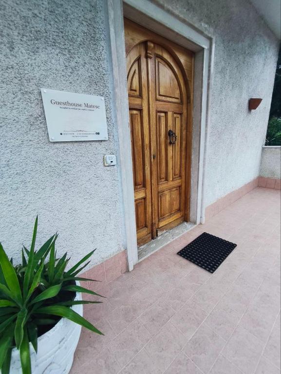 a wooden door of a house with a potted plant at Guesthouse Matese in Piedimonte dʼAlife