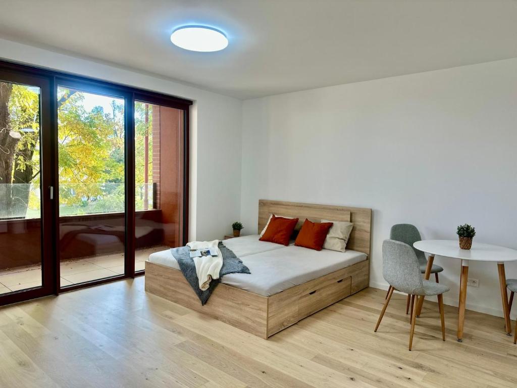 a bedroom with a bed and a table at Bratislava in Nivy