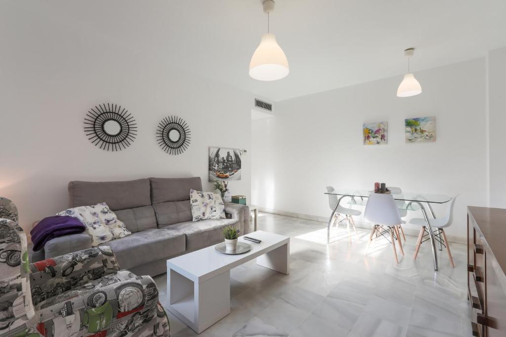 a living room with a couch and a table at Fabled Parking in Seville
