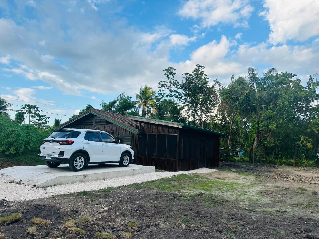 a white car parked in front of a building at Howler Landing Vacation Rental in Bermudian Landing
