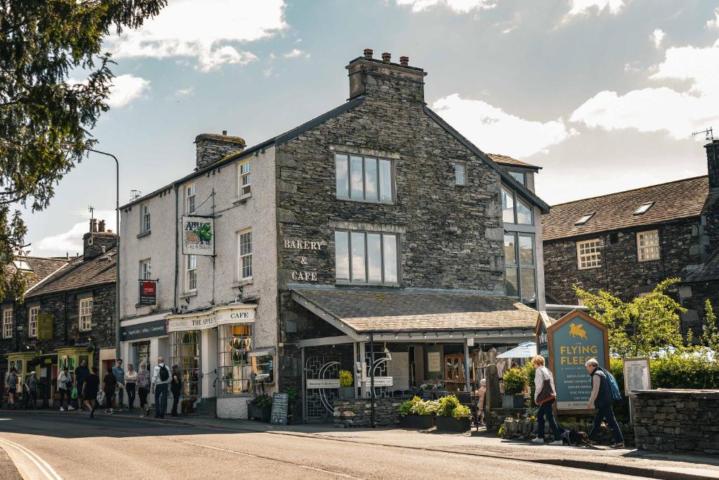 a group of people walking down a street in front of a building at The Apple Loft Rooms in Ambleside
