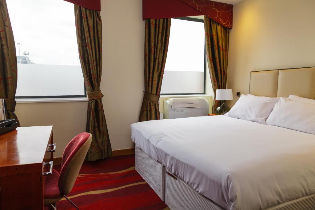 Ένα ή περισσότερα κρεβάτια σε δωμάτιο στο ICON Hotel