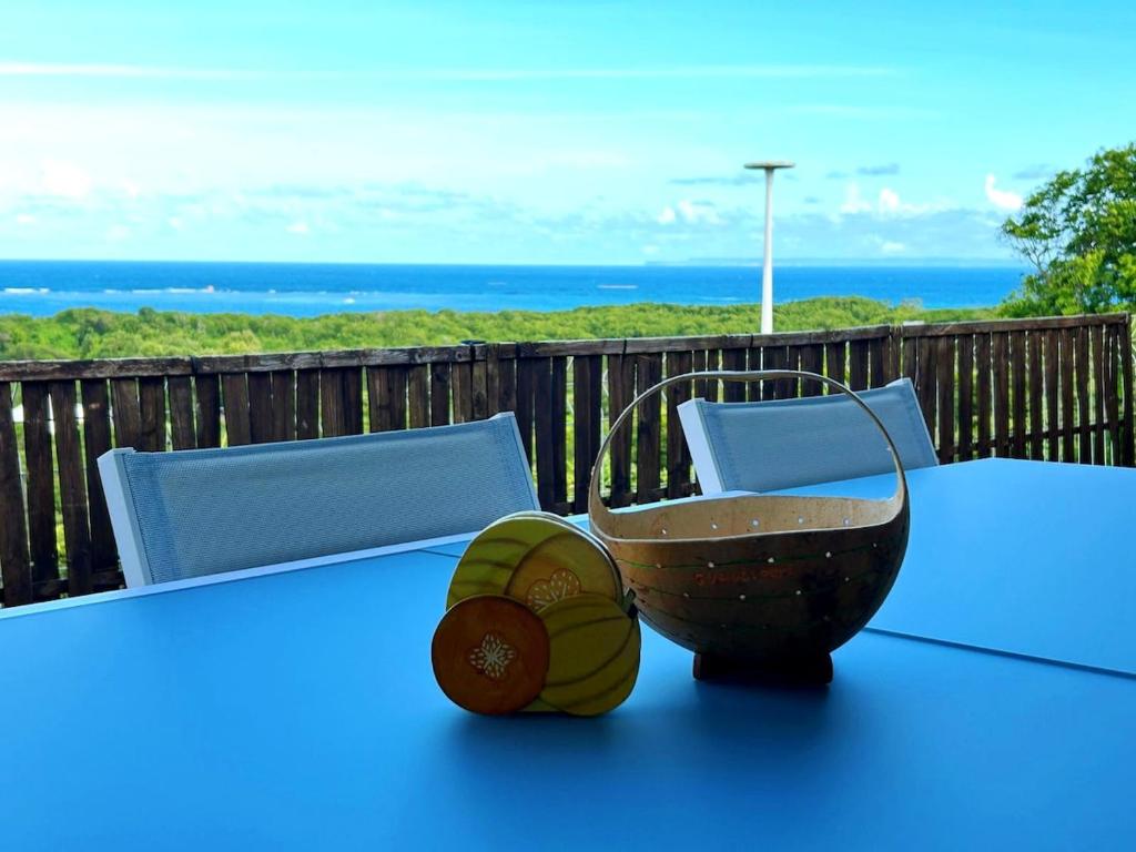 a table with a bowl on top of a table at L'écrin des Salines, votre escale tropicale in Le Gosier
