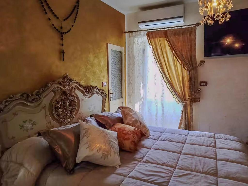 a bedroom with a large bed and a window at Casa Tre in Mussomeli