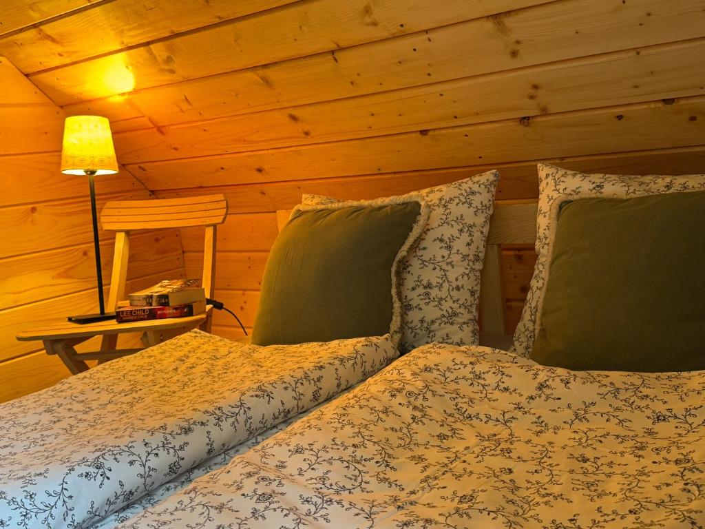 a bedroom with two beds in a log cabin at Chata na Wzgórzu in Ochotnica Dolna