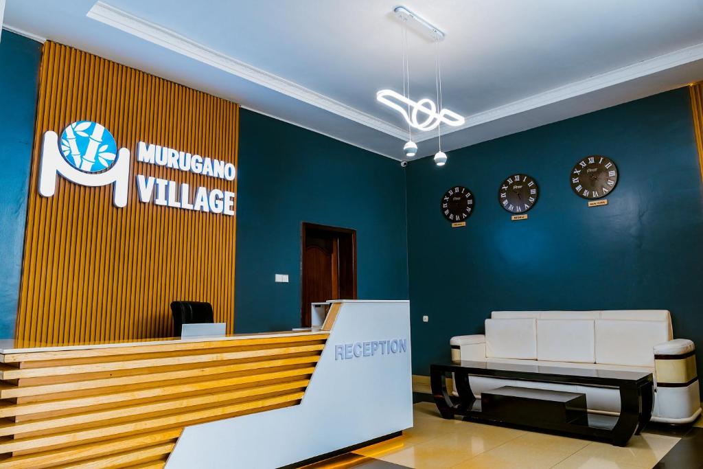 an office with a waiting area with clocks on the wall at Murugano Village Hotel in Taba