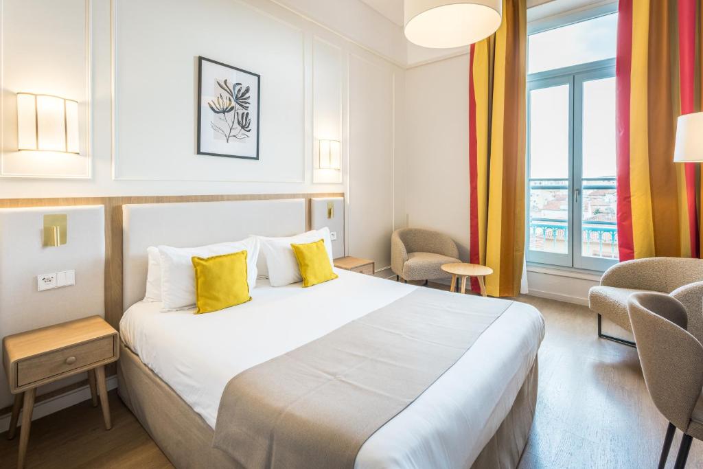 Ένα ή περισσότερα κρεβάτια σε δωμάτιο στο Hôtel Miléade L'Orangeraie - Menton