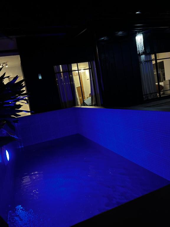 a dark room with a blue light in a building at Boxify Cabins 