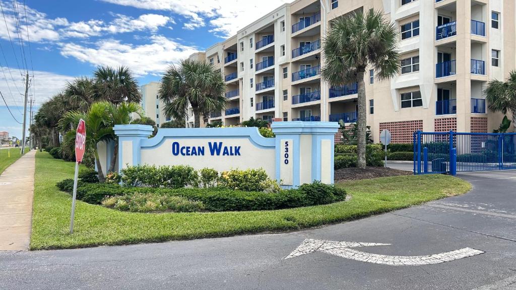 a sign for a oceanwalk sign in front of a building at Seashell Escape in New Smyrna Beach