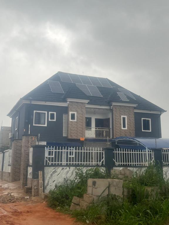 a house with solar panels on the roof at GG suites and Apartments in Owerri