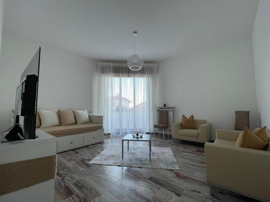 a living room with a couch and a tv at Casa Vacanze Ilenia in Marina di Montemarciano