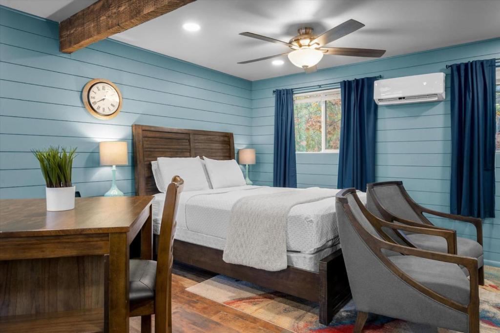 a bedroom with a bed and a desk and a clock at 15 Creekside Retreat in Sedona