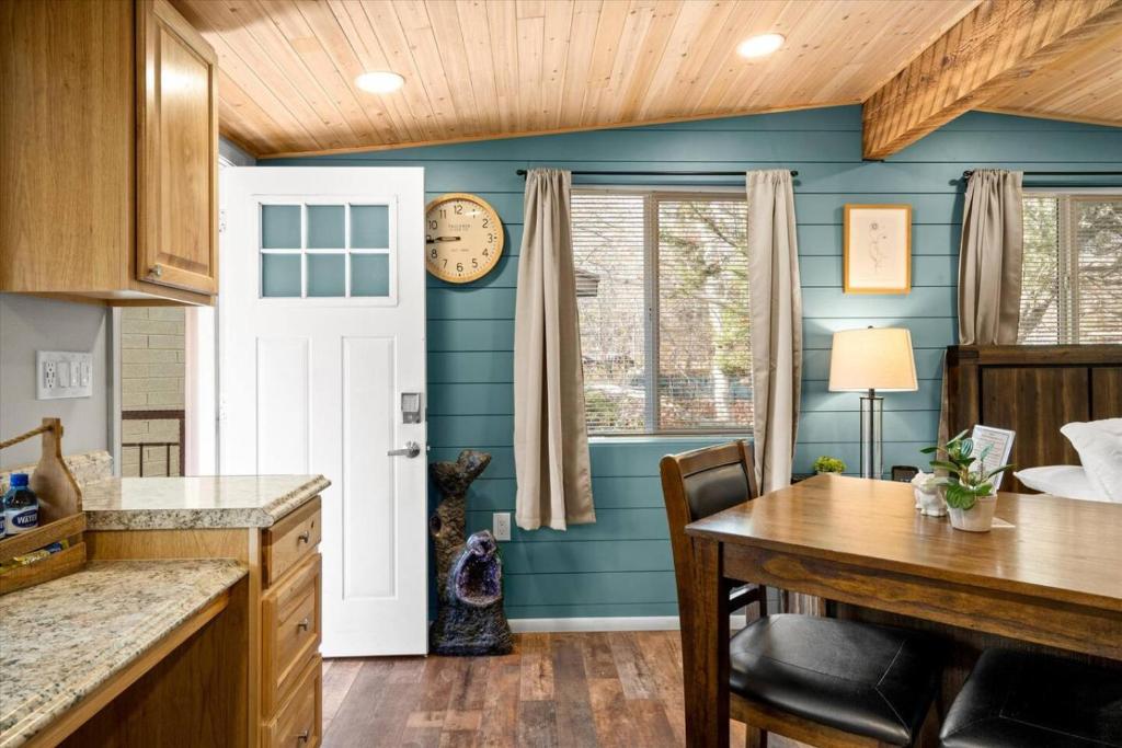 a kitchen with a table and a clock on the wall at 18 Creekside Retreat in Sedona