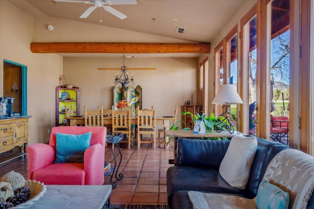 a living room with a couch and a dining room at Adobe Hacienda - Anasazi Suite in Oak Creek