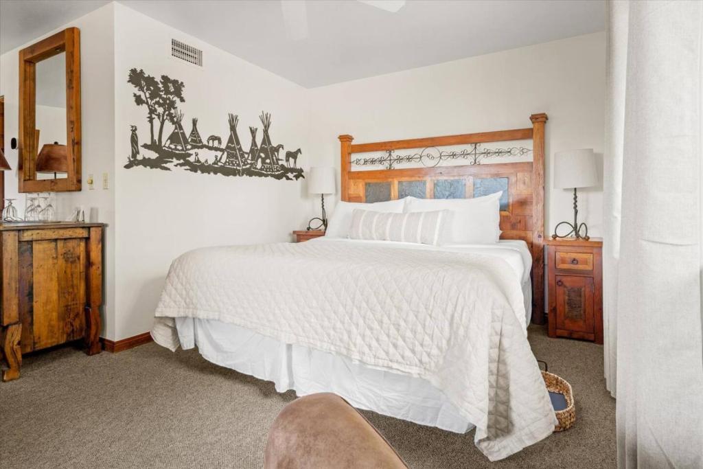 a bedroom with a large white bed and a chair at Adobe Village Suite- Painted Desert in Sedona