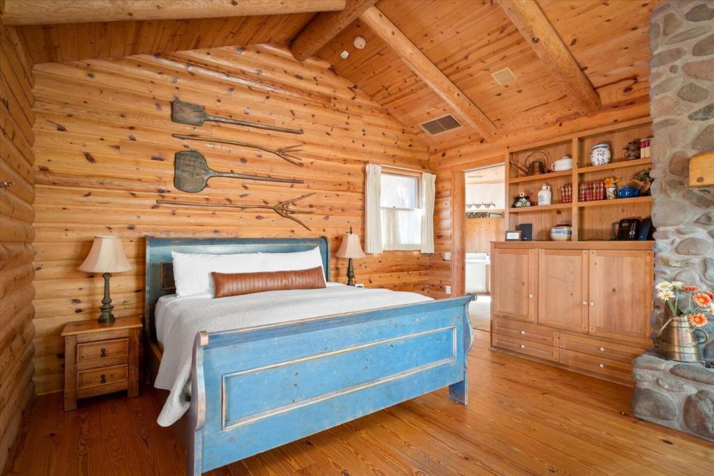 ein Schlafzimmer mit einem Bett in einer Blockhütte in der Unterkunft Adobe Village Villa with Private Patio- Wilderness in Oak Creek