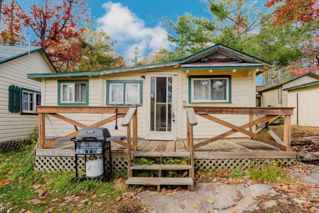 a house with a grill on the front of it at 2-Bedroom Cottage #5 - Lodgepole Pine in Gravenhurst