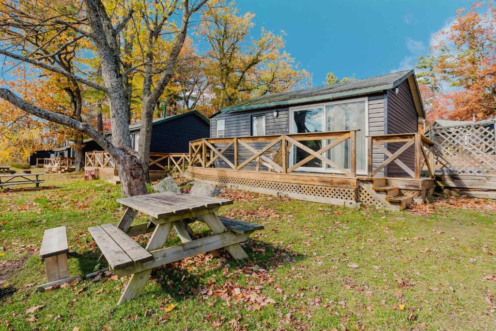 a picnic table in front of a cabin at Studio Cottage #8 - Jack Pine in Gravenhurst