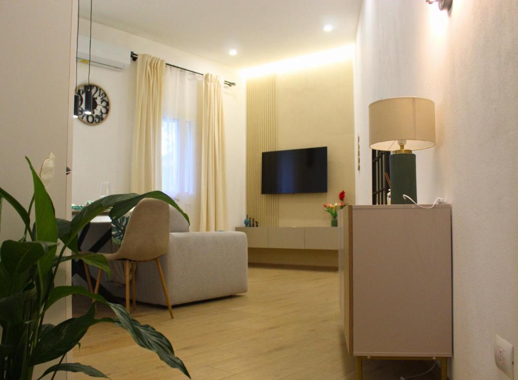 un soggiorno con un divano e una TV di Garden Suite Milano - Vero Gioiello con Giardino a 5 minuti da Mediaset e San Raffaele a Cologno Monzese