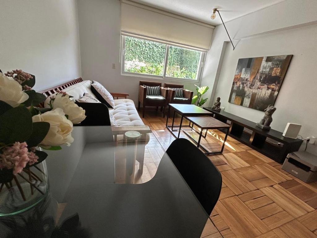 a living room with a couch and a table at Bicentenario Park Apartment in El Cerrillo