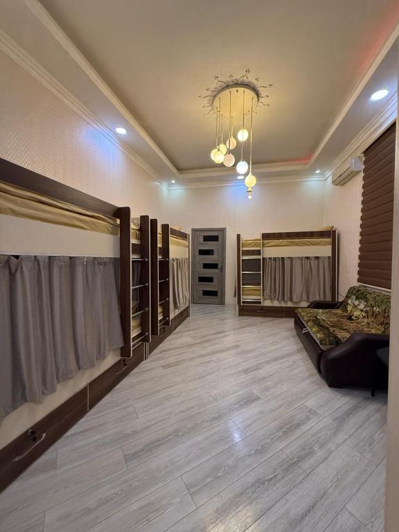 a large room with bunk beds and a couch at Caspian Hostel in Baku