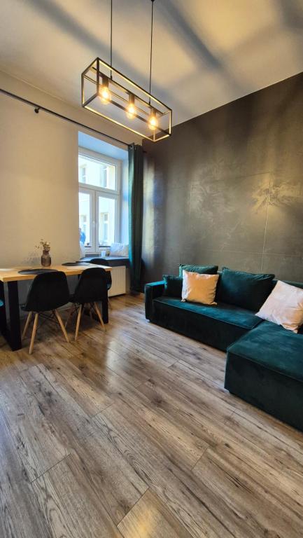a living room with a couch and a table at Apart Complex Green Rewolucji 27 in Łódź
