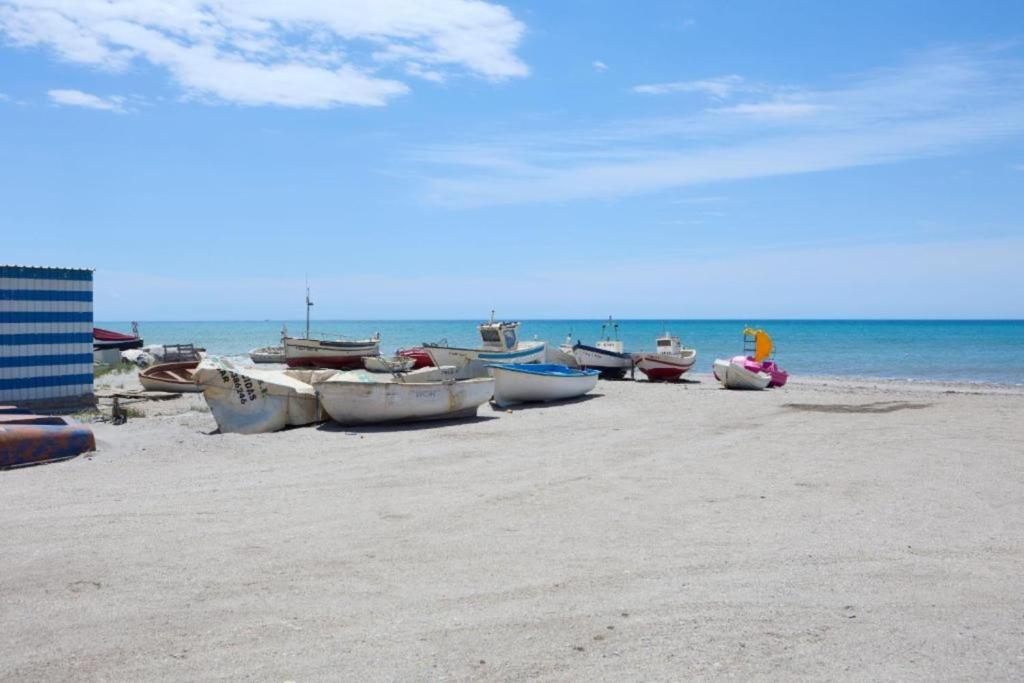 a group of boats sitting on the beach at Apartalux Zen Pacific in El Cabo de Gata